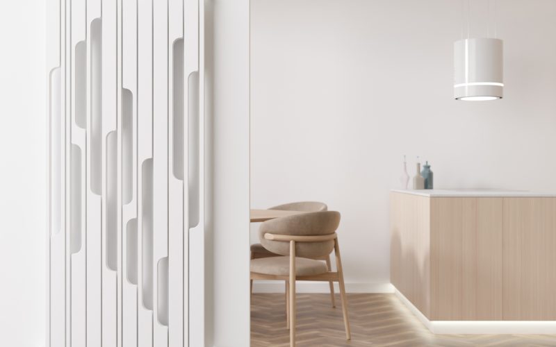 White heating radiator on white wall in modern room. Home interior. Beautiful design radiator